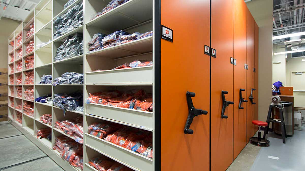 mobile shelving storing football apparel on sliding rails