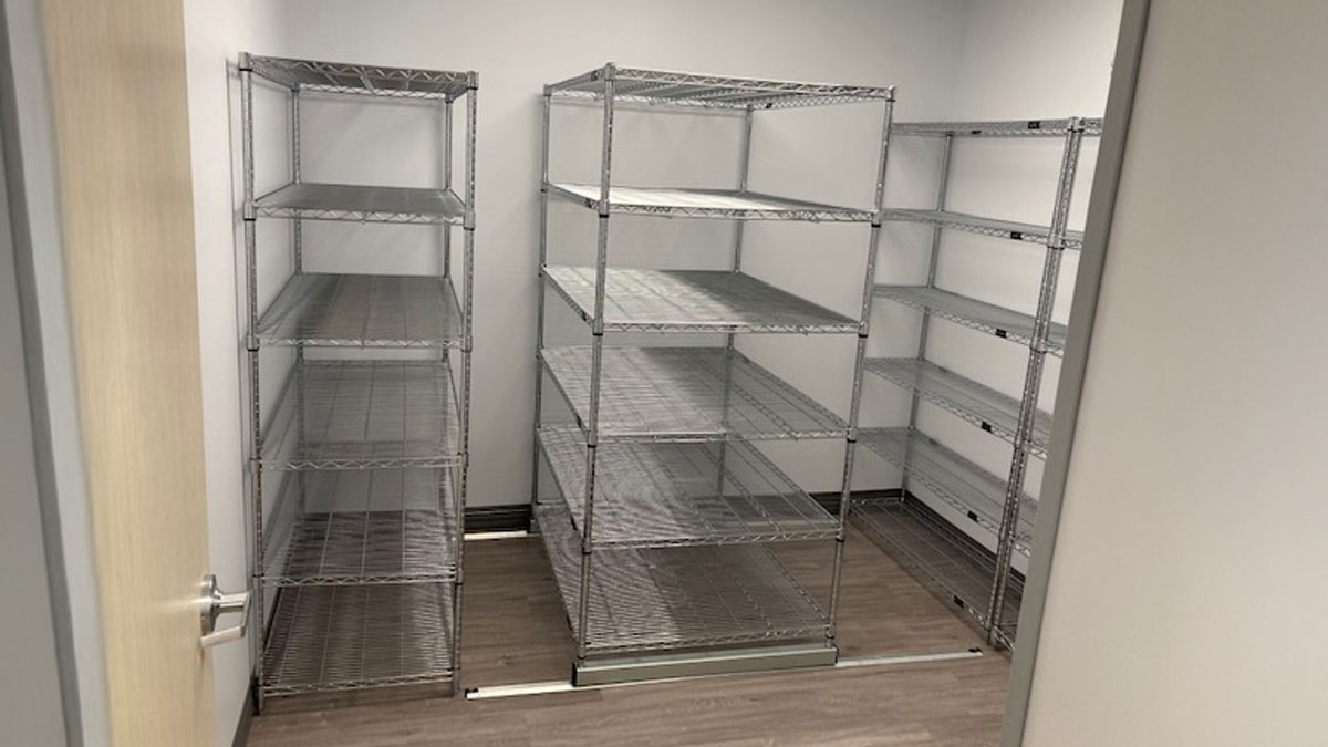 Sliding shelving units in a surgery center for efficient medical record storage and easy access
