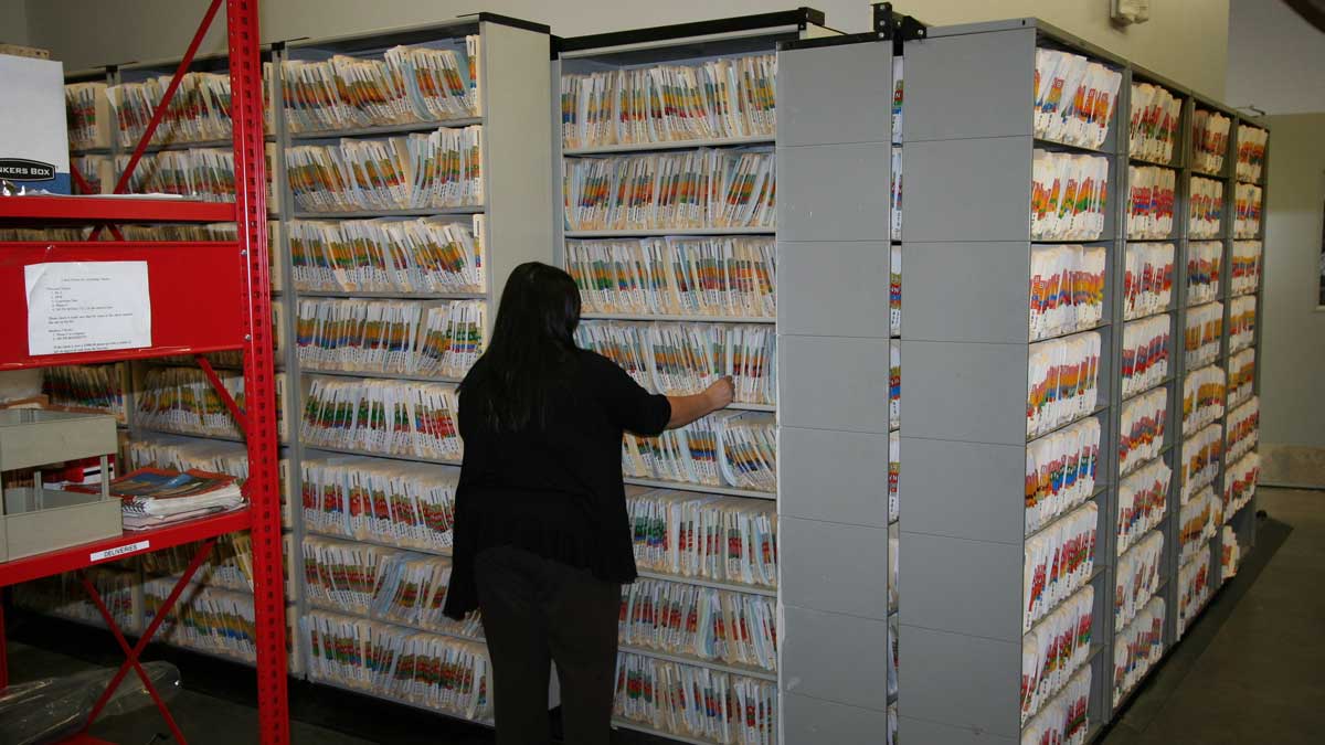 Rolling file storage shelves in a car dealership's parts department for efficient file and document access