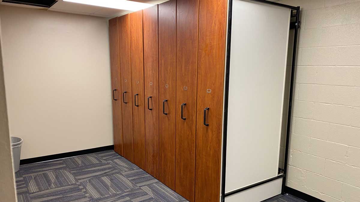 Pull-out shelving system for industrial storage, streamlining workspace organization and optimizing available floor area