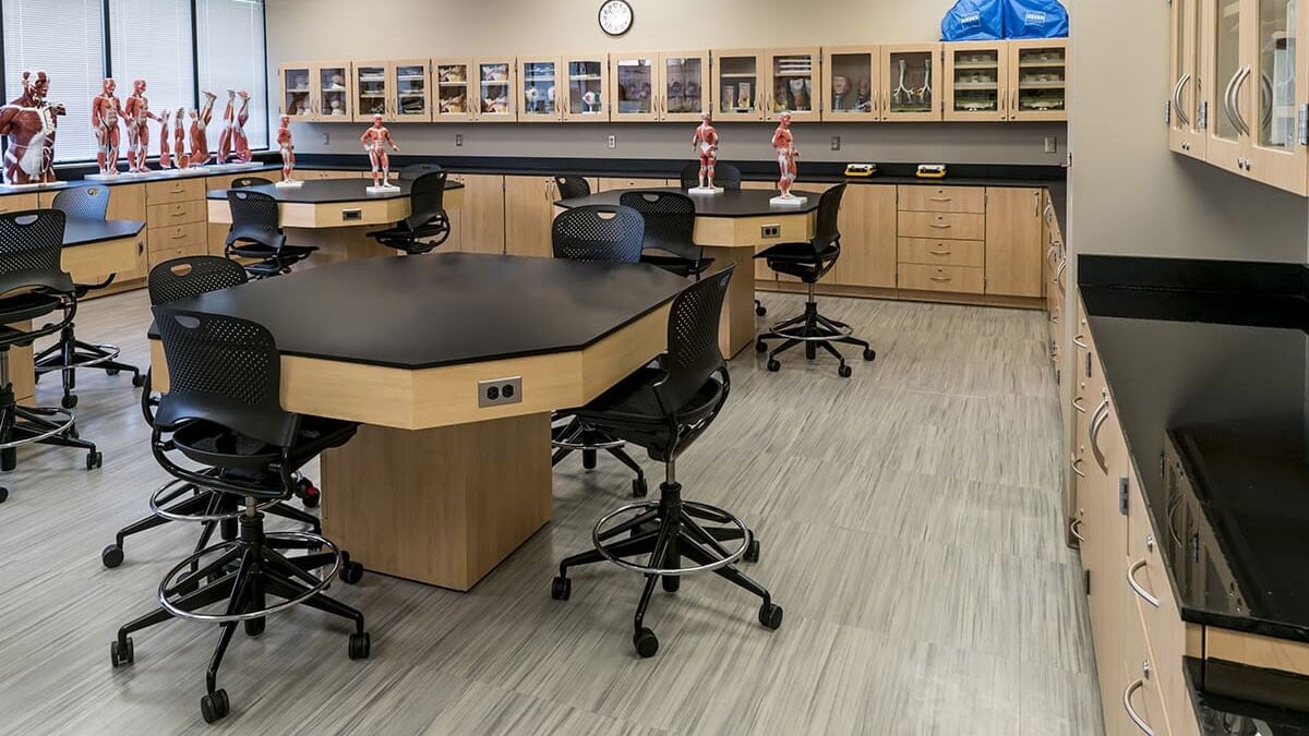 Science classroom with modular lab casework, storage cabinets, and student workstations.