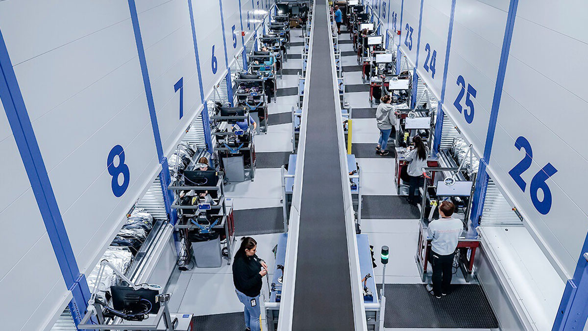 Automated vertical lift storage system supporting order picking in a warehouse fulfillment facility.