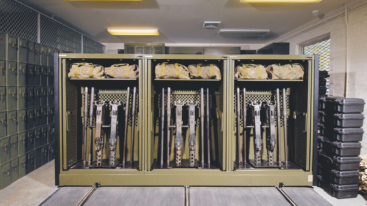 Secure military weapons storage cabinets organizing firearms and equipment in a controlled access room.