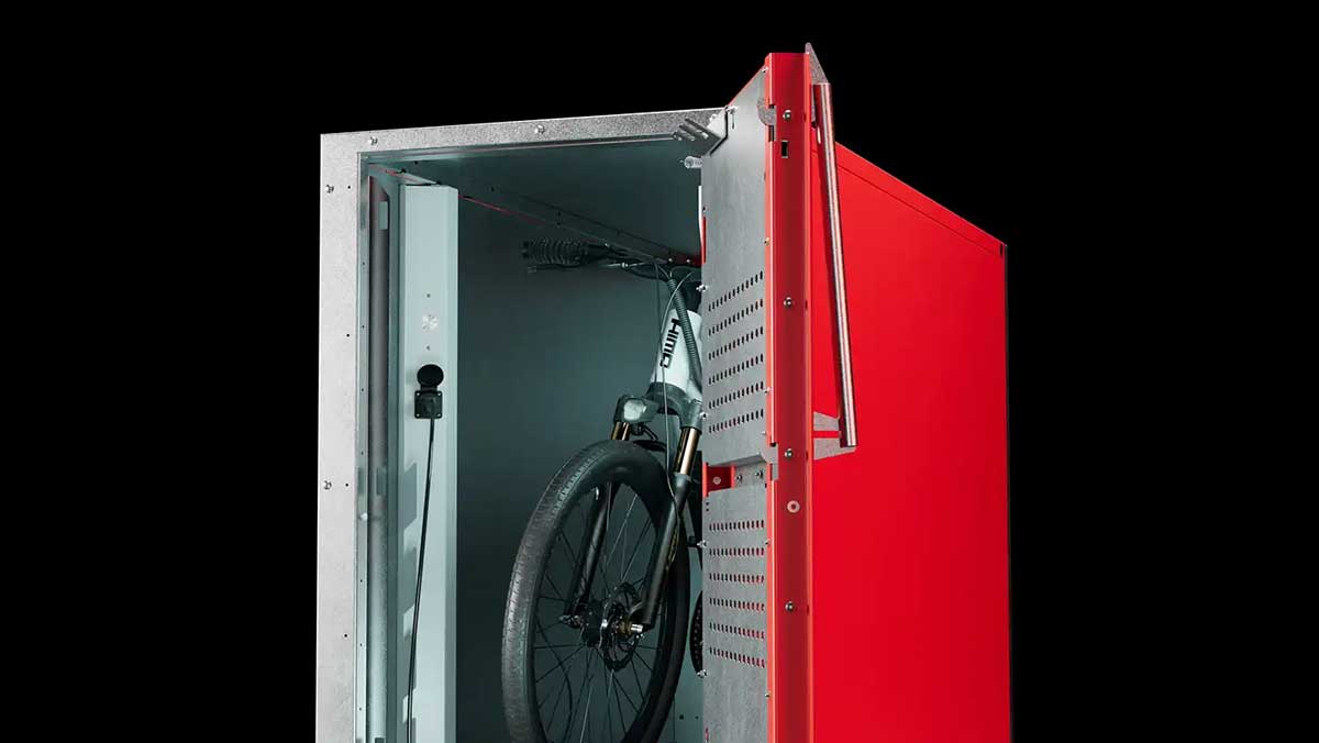 Interior of single e‑bike locker with rack and charging port