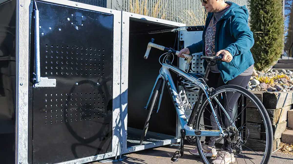Interior view of double-sided bike locker showing two bicycle compartments and central dividing panel.