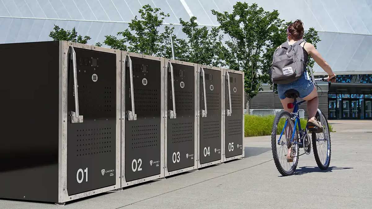 Outdoor installation of smart bike lockers with numbered doors and QR-code access panels.