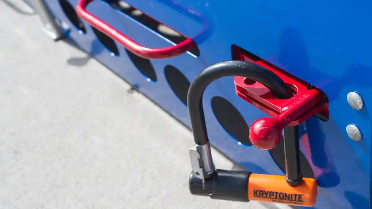 Close-up of U-lock secured through mounting bracket on veloport storage unit.