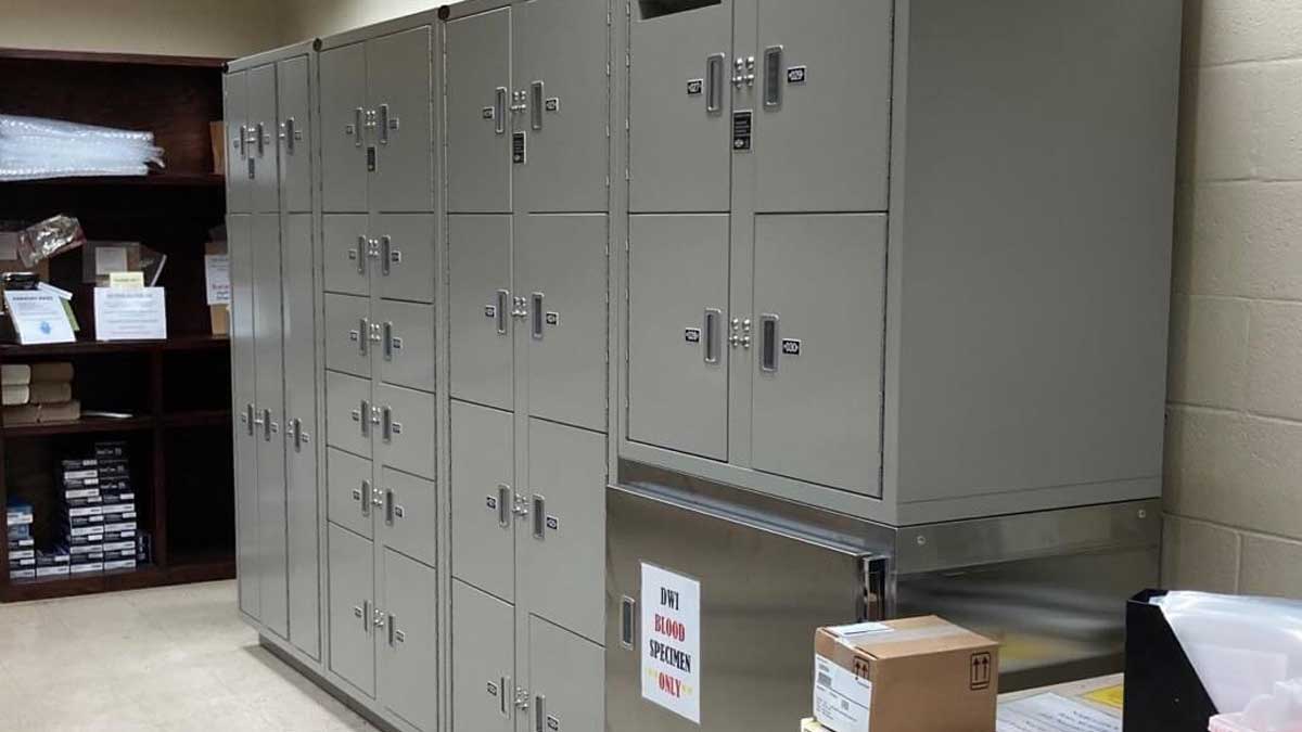 Keyless deposit drop-off evidence lockers with numbered compartments in evidence room