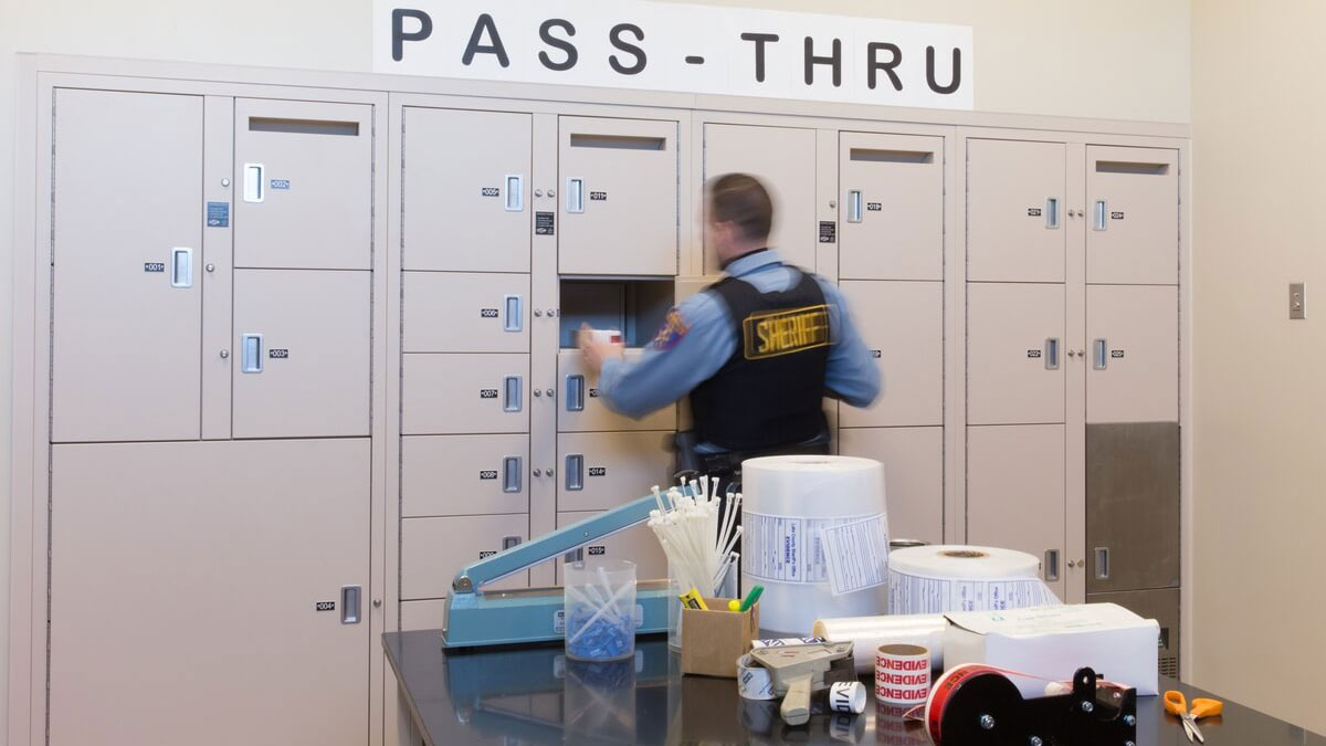 Officer accessing pass-through evidence lockers