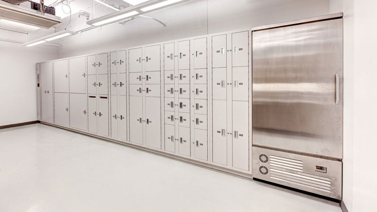 Secure pass-through evidence lockers with refrigeration in clean white forensic storage room