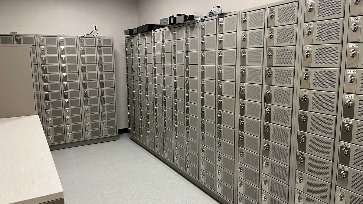 Secure stainless steel phone lab evidence lockers in government facility with individual locking compartments