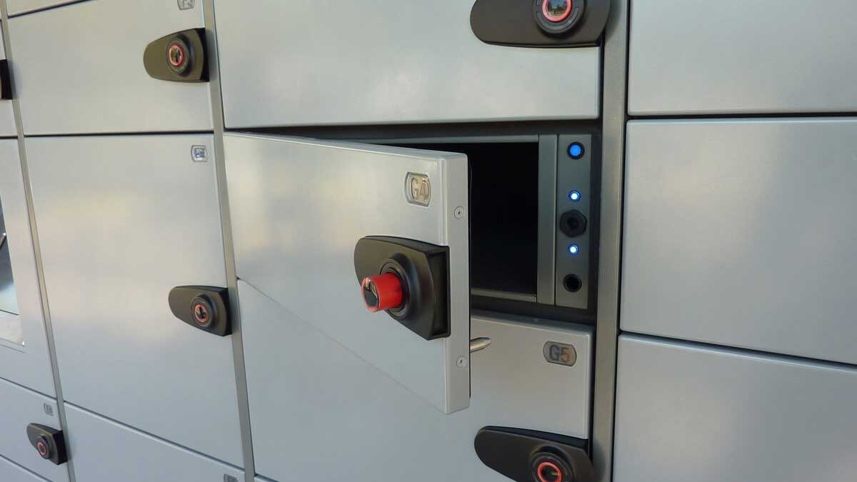 Close-up view of smart parcel delivery lockers with LED indicators and secure electronic access control system.
