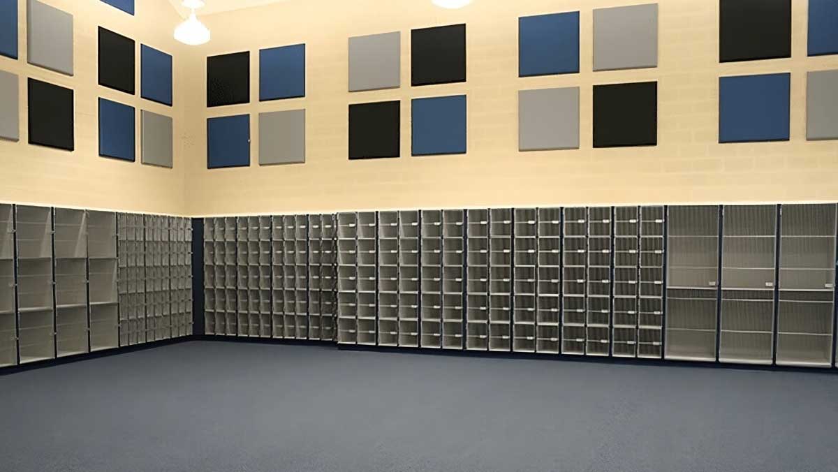 Wall of modular instrument shelving units with acoustic panels in a music classroom or band room