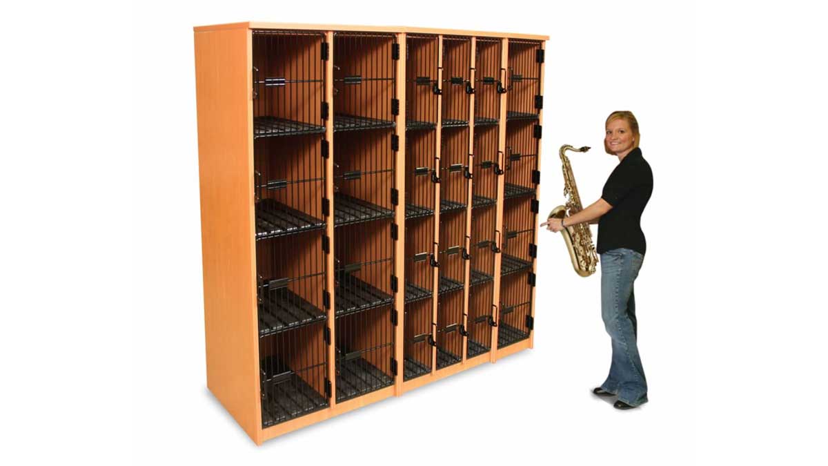 Student placing saxophone in a band locker