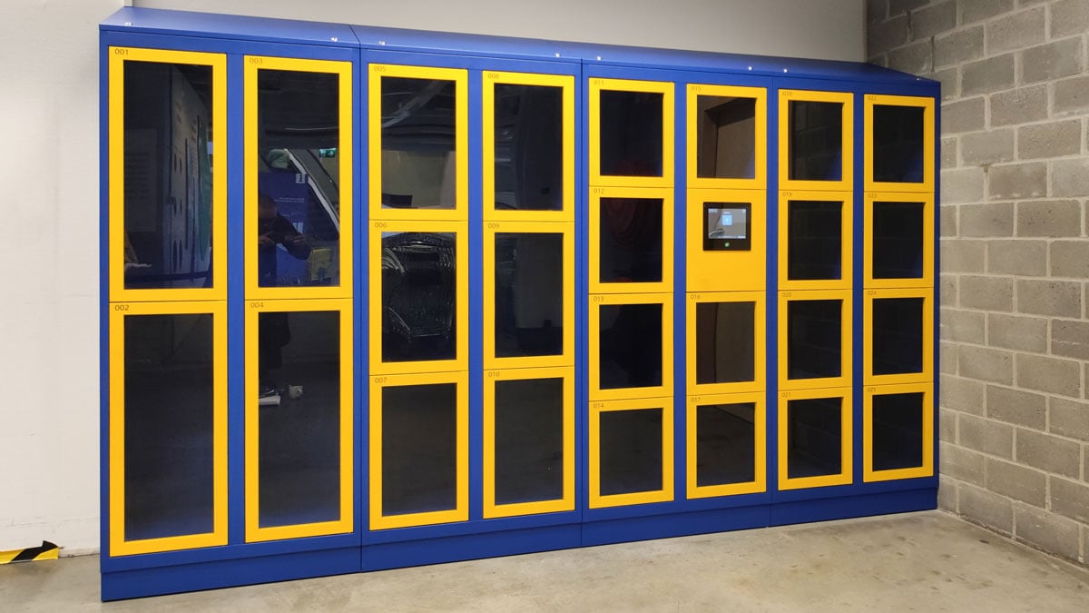 smart locker bank with blue and yellow doors in an industrial setting