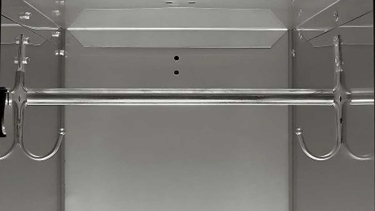 Interior of a stainless steel locker with hanging rod and hooks