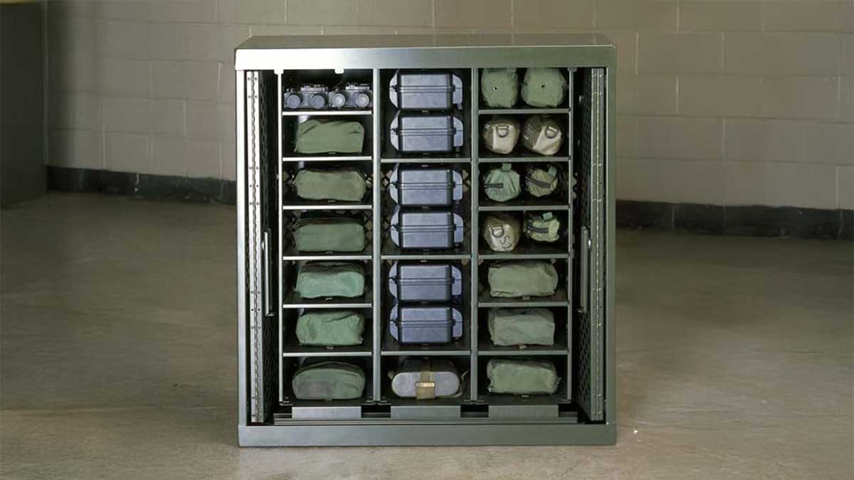 Military gear storage locker cabinet organized with tactical vests, helmets, and cases