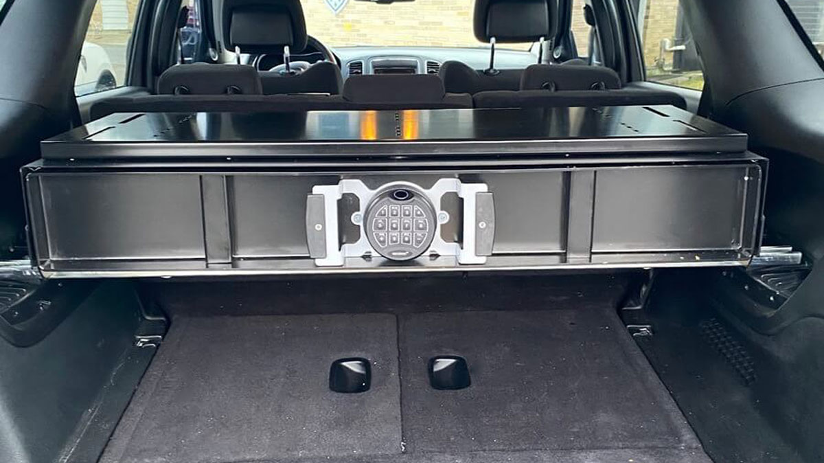 Rear seat mounted gun safe for SUVs with secure locking mechanism designed for tactical use