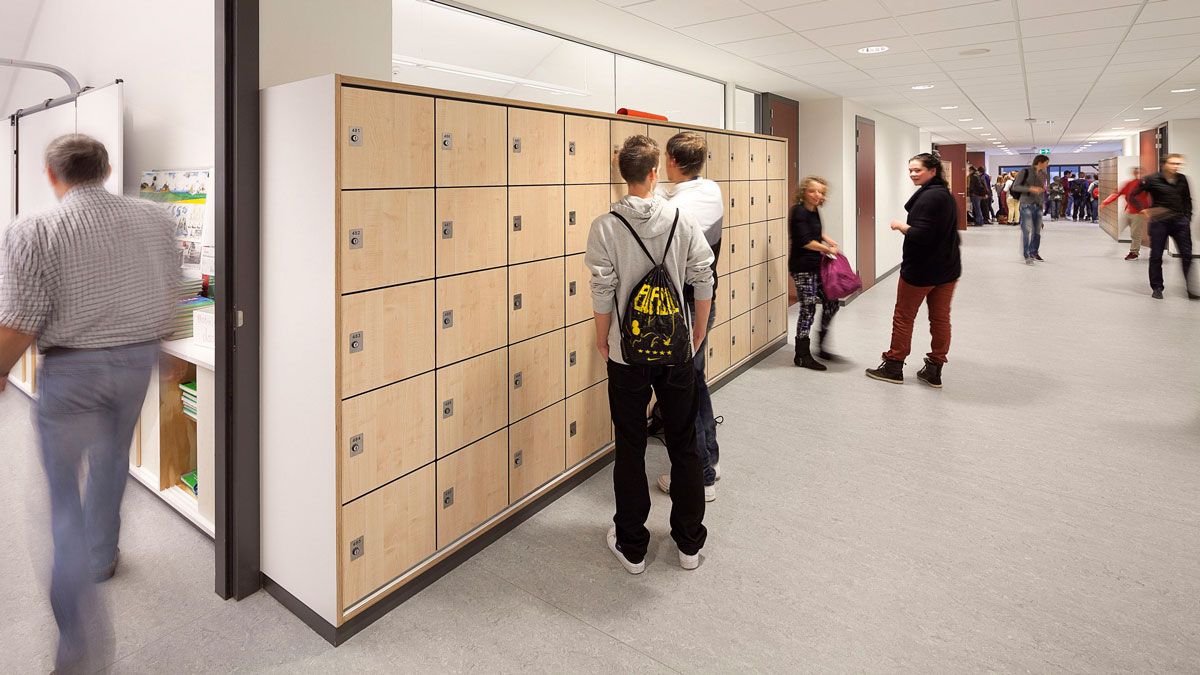 school hallway with students and wood finish lockers for personal storage