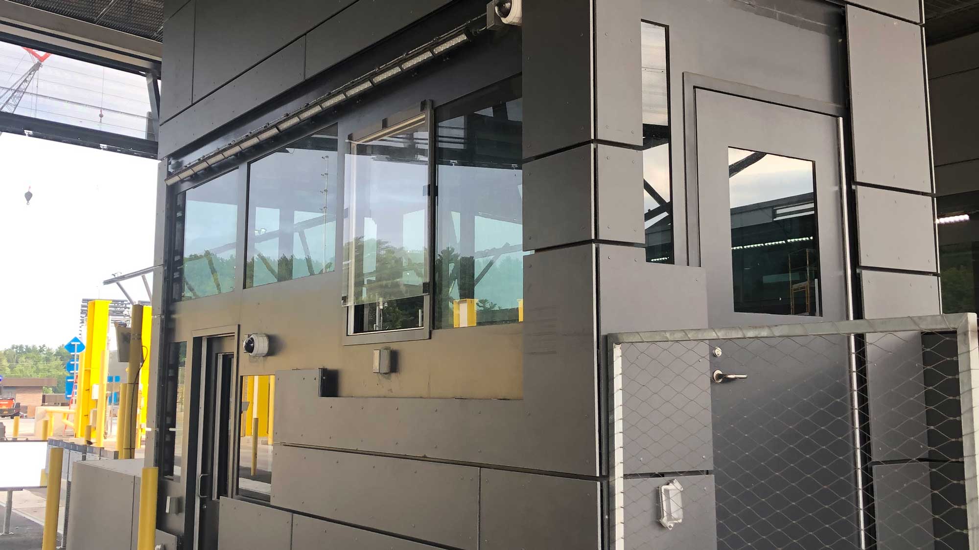 security kiosk with multiple viewing windows and entry door for site monitoring and personnel safety