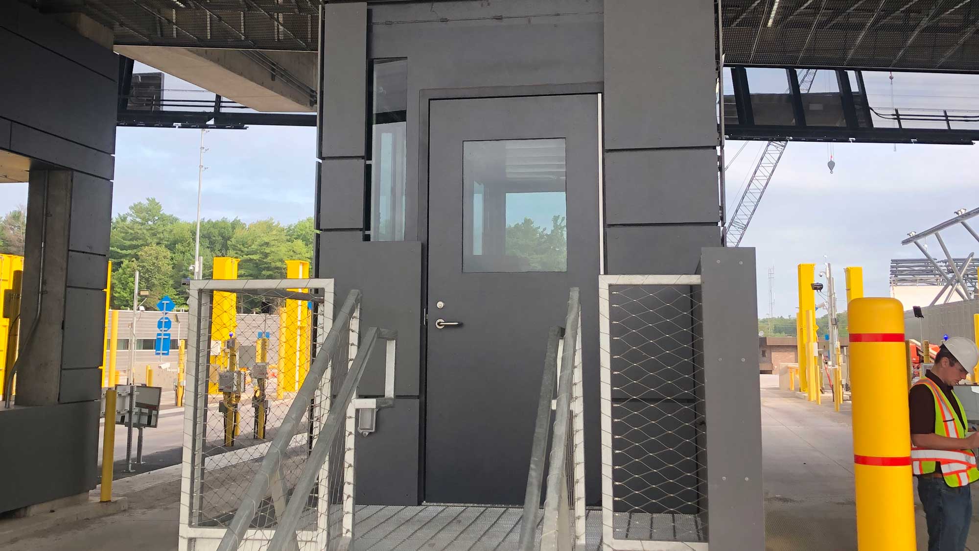 secure entry kiosk with railed access for controlled point-of-entry and guard oversight