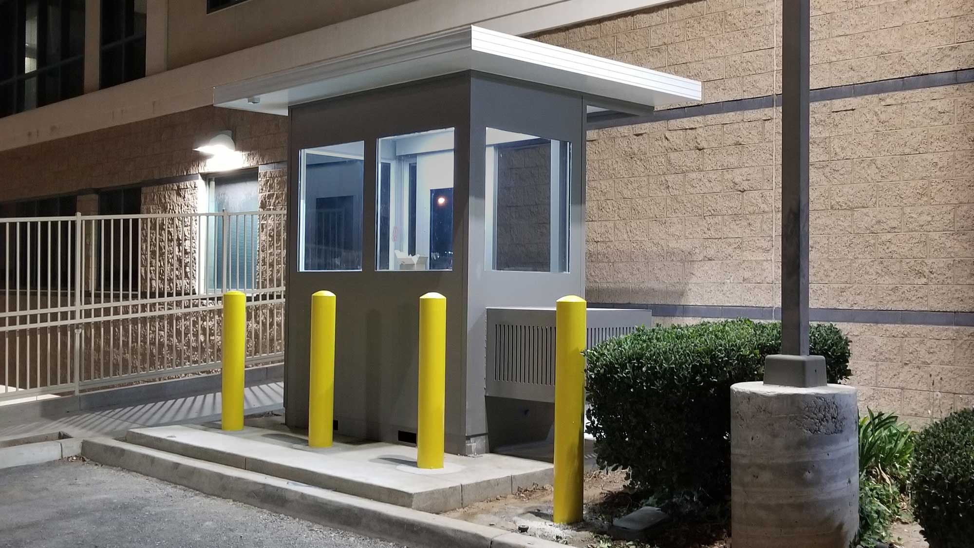 Security checkpoint booth with bollard protection for controlled entry and monitoring