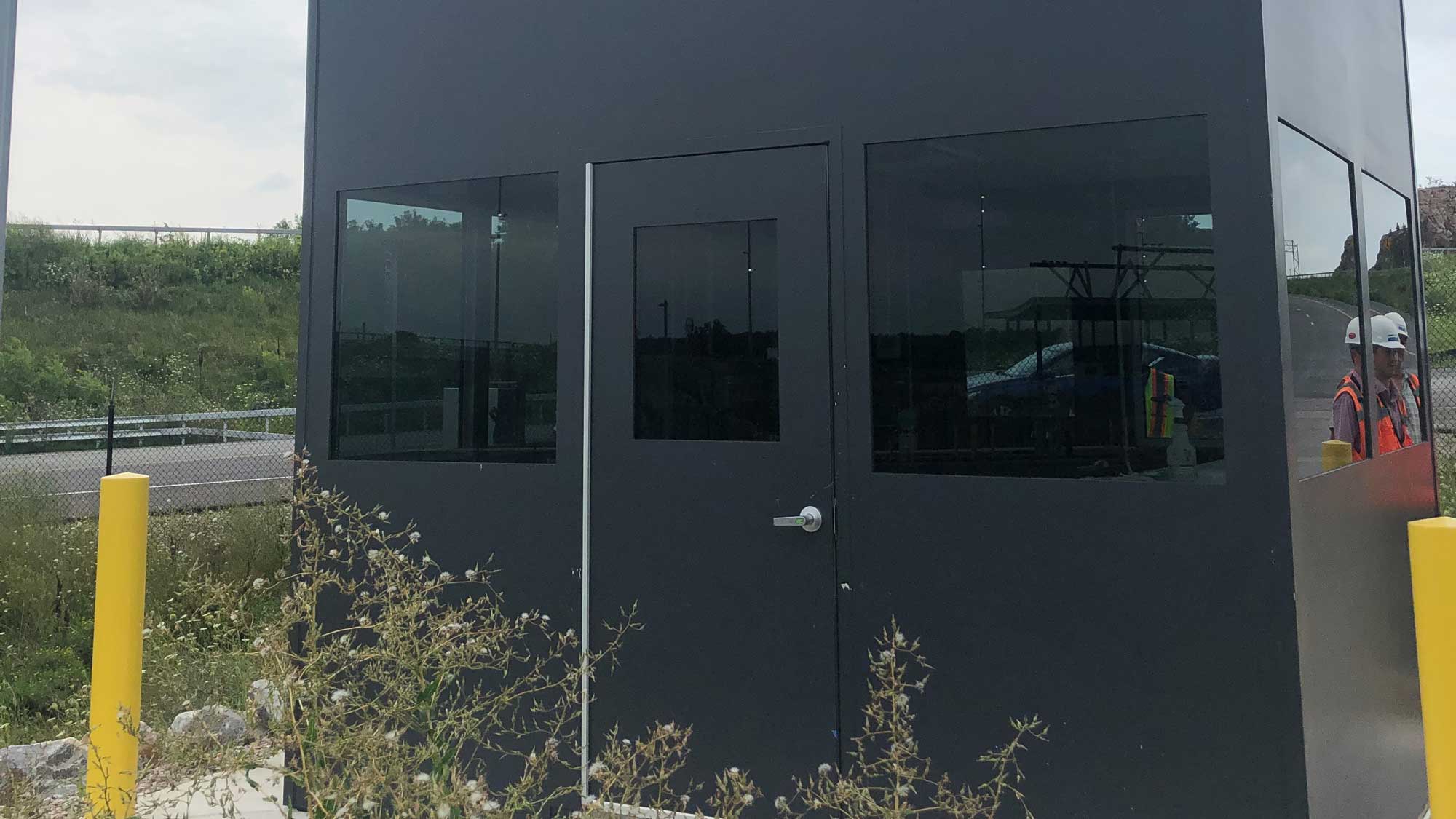 security booth with tinted viewing windows and central door for guarded entry control
