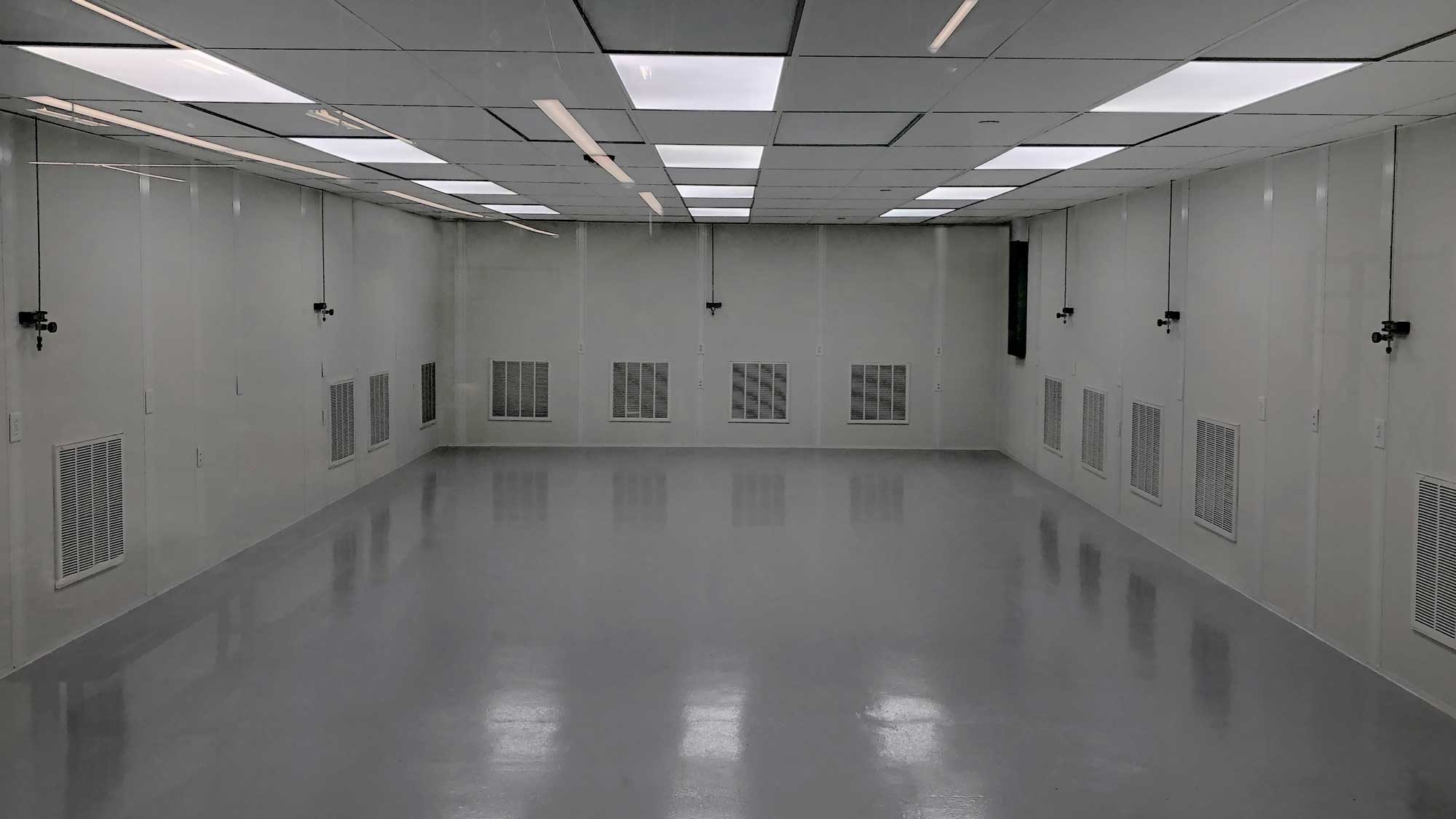 Cleanroom interior with filtered air return louvers and suspended ceiling grid
