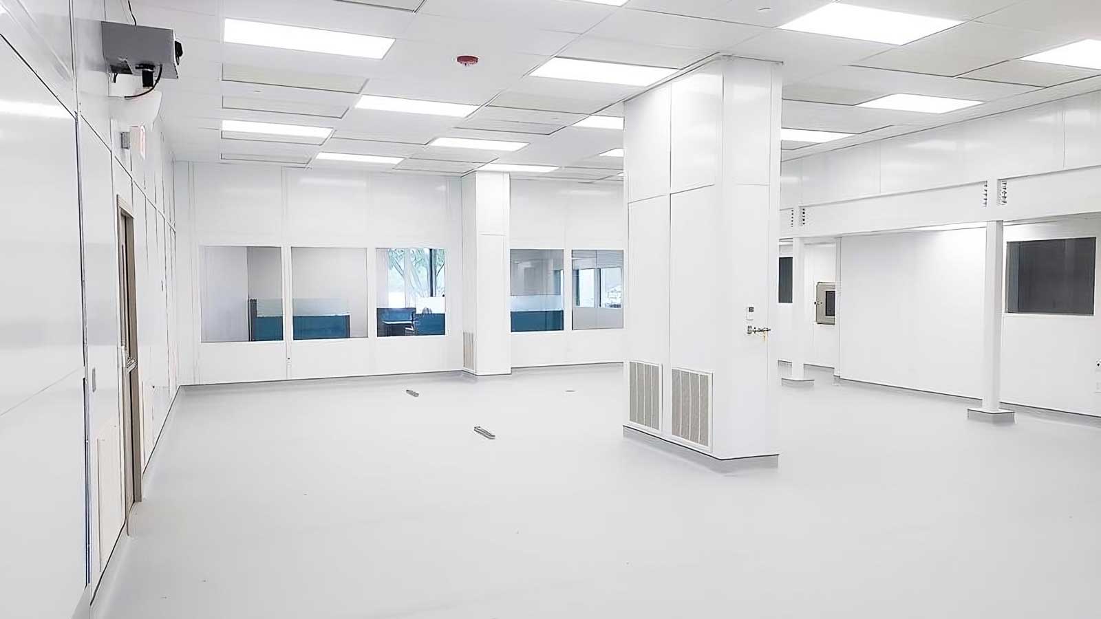 Empty modular cleanroom interior with ceiling grid and air return louvers