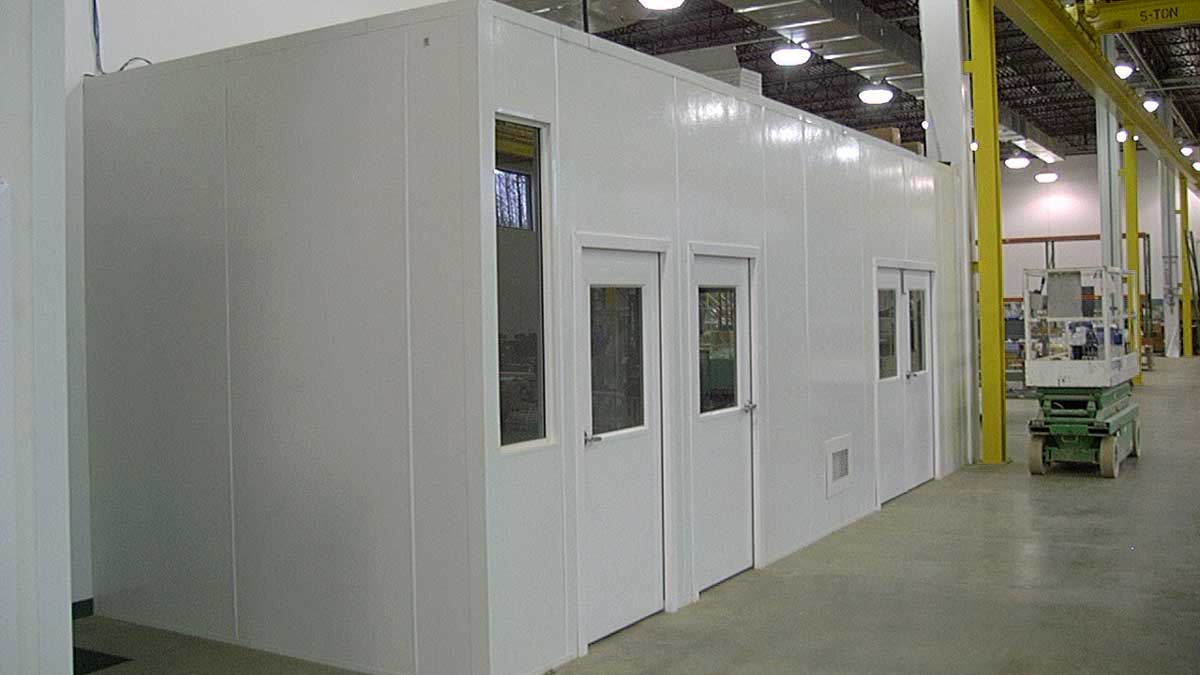 Modular panel cleanroom with windowed doors and ventilation louvers