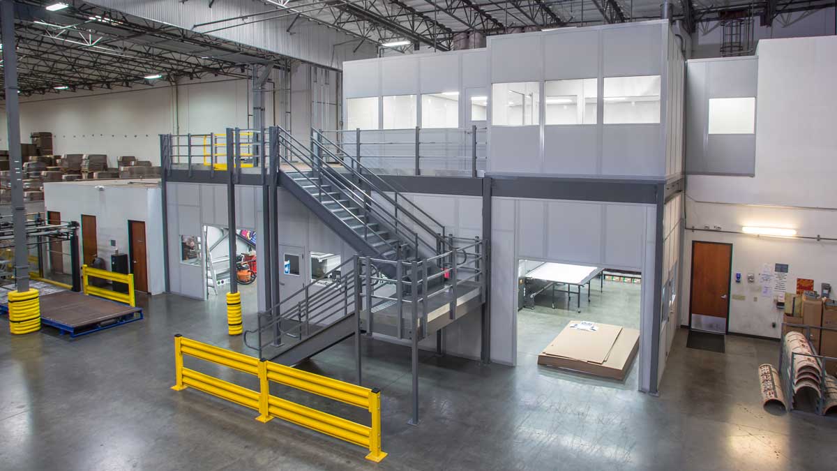 Modular mezzanine inplant office providing elevated work area with staircase access
