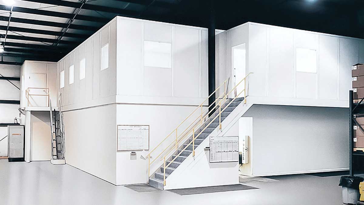 Two-story in-plant office with staircase installed inside an industrial facility