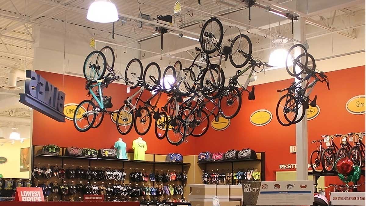 overhead retail bike display rack organizing bicycles in showroom to maximize product visibility