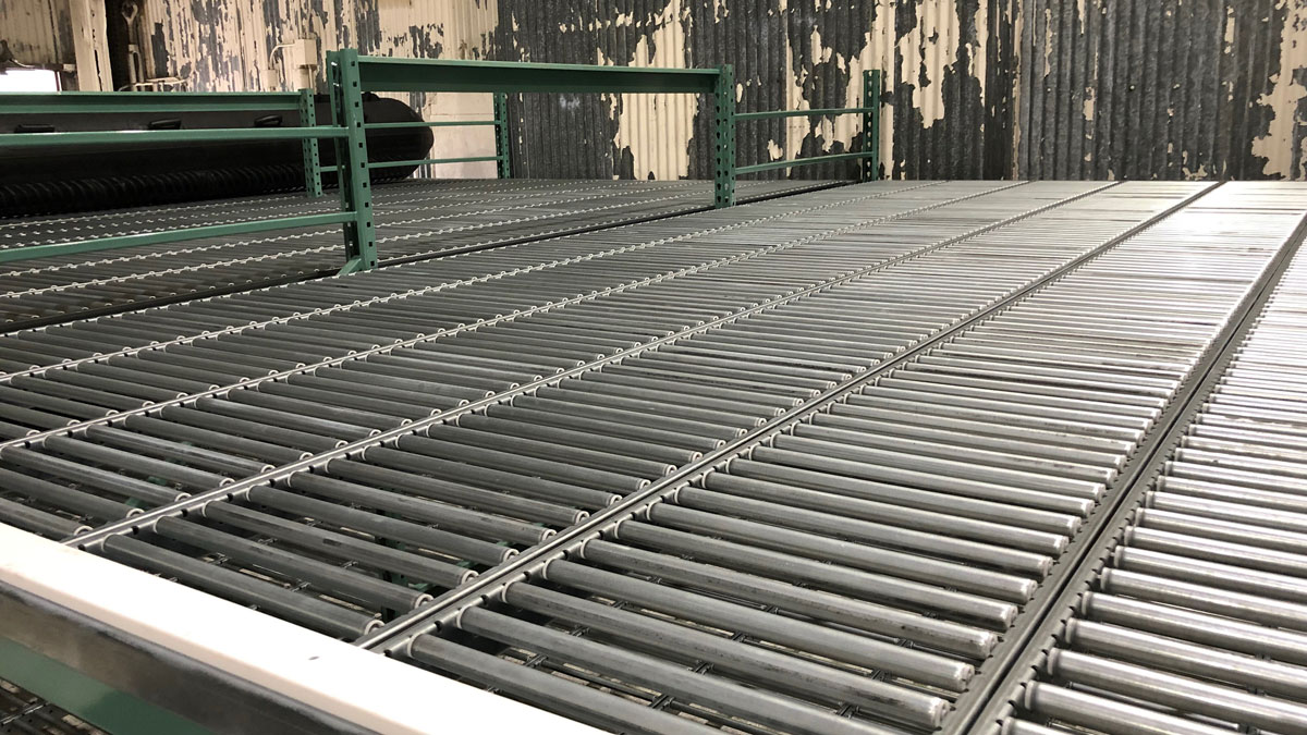 Military base storage with gravity flow racks used to hold inflatable boats in a secure and organized manner