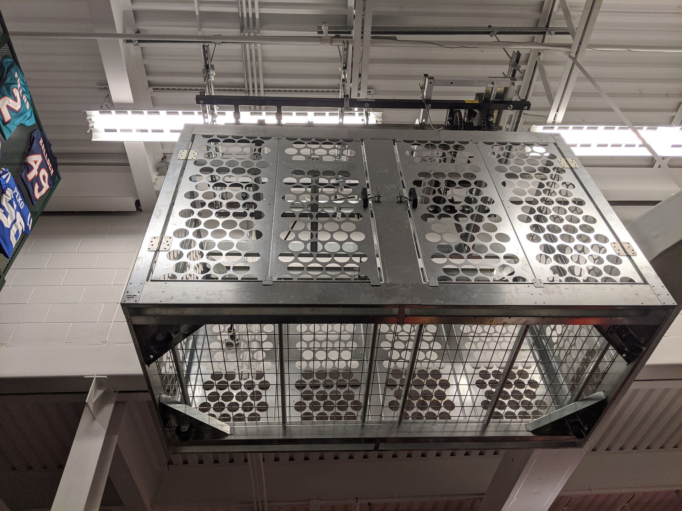 overhead storage racks installed in a school for sports equipment storage