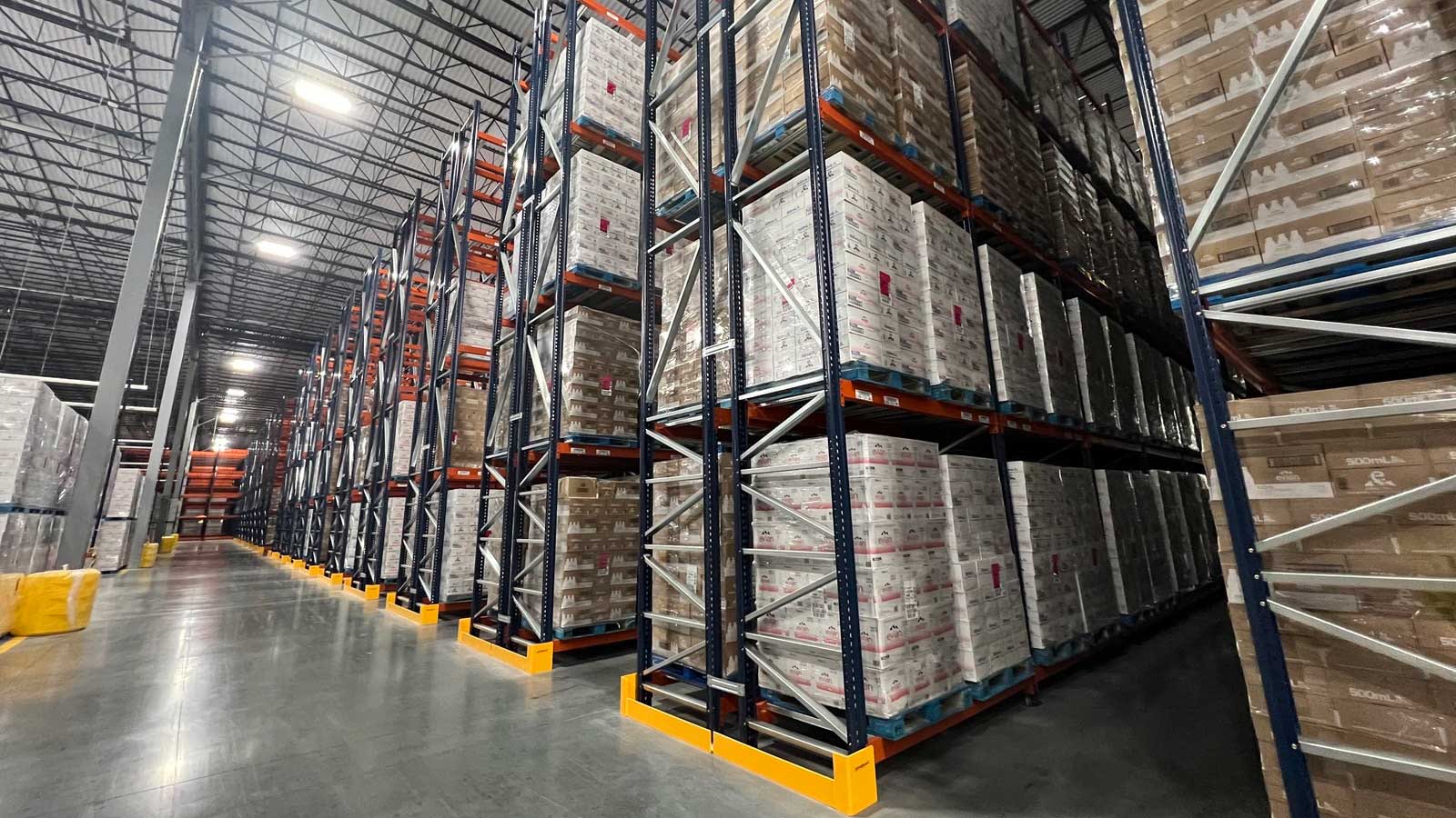 Post protector guarding pallet rack upright in a fast pick zone