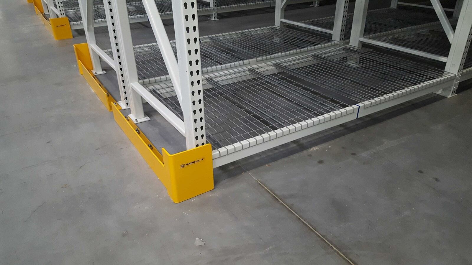 Square post rack protector shielding rack upright near a production line