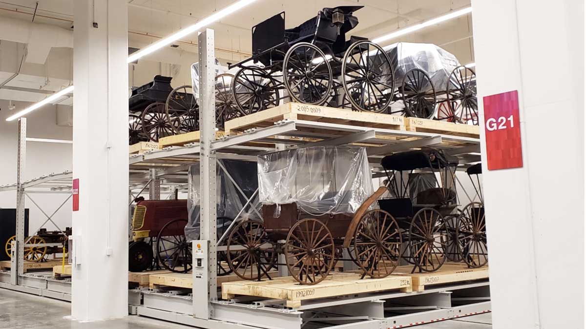historic carriages stored securely on wide span mobile shelving units for preservation and display