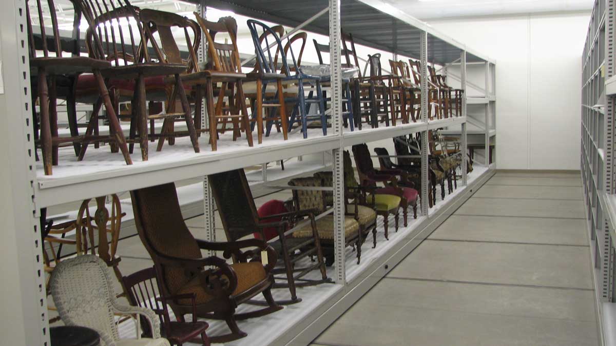 wide span shelving system for museum collection storage of chairs, artifacts, and antiques