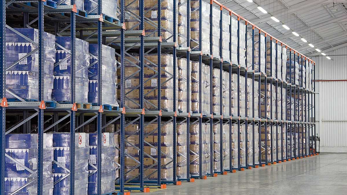 pallet shelving units arranged for order picking in warehouse aisle