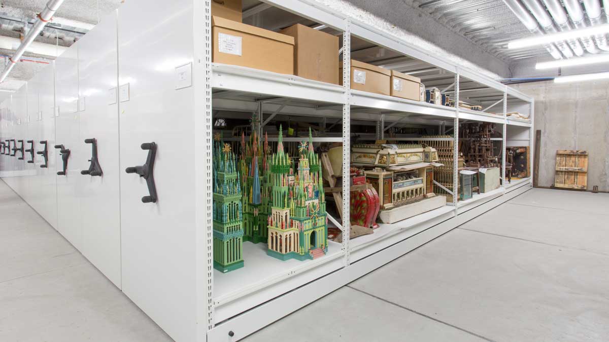 wide span shelving in museum collection room with storage bins for organized artifact placement