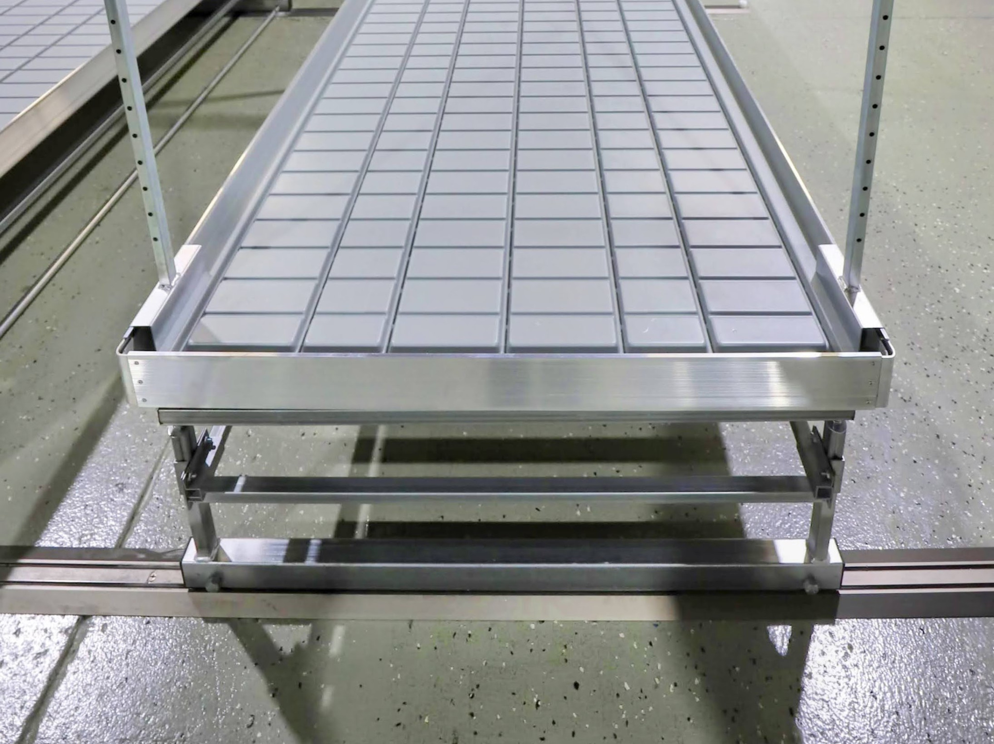 Rail guided platform bench shows deck and base detail for controlled movement on tracks