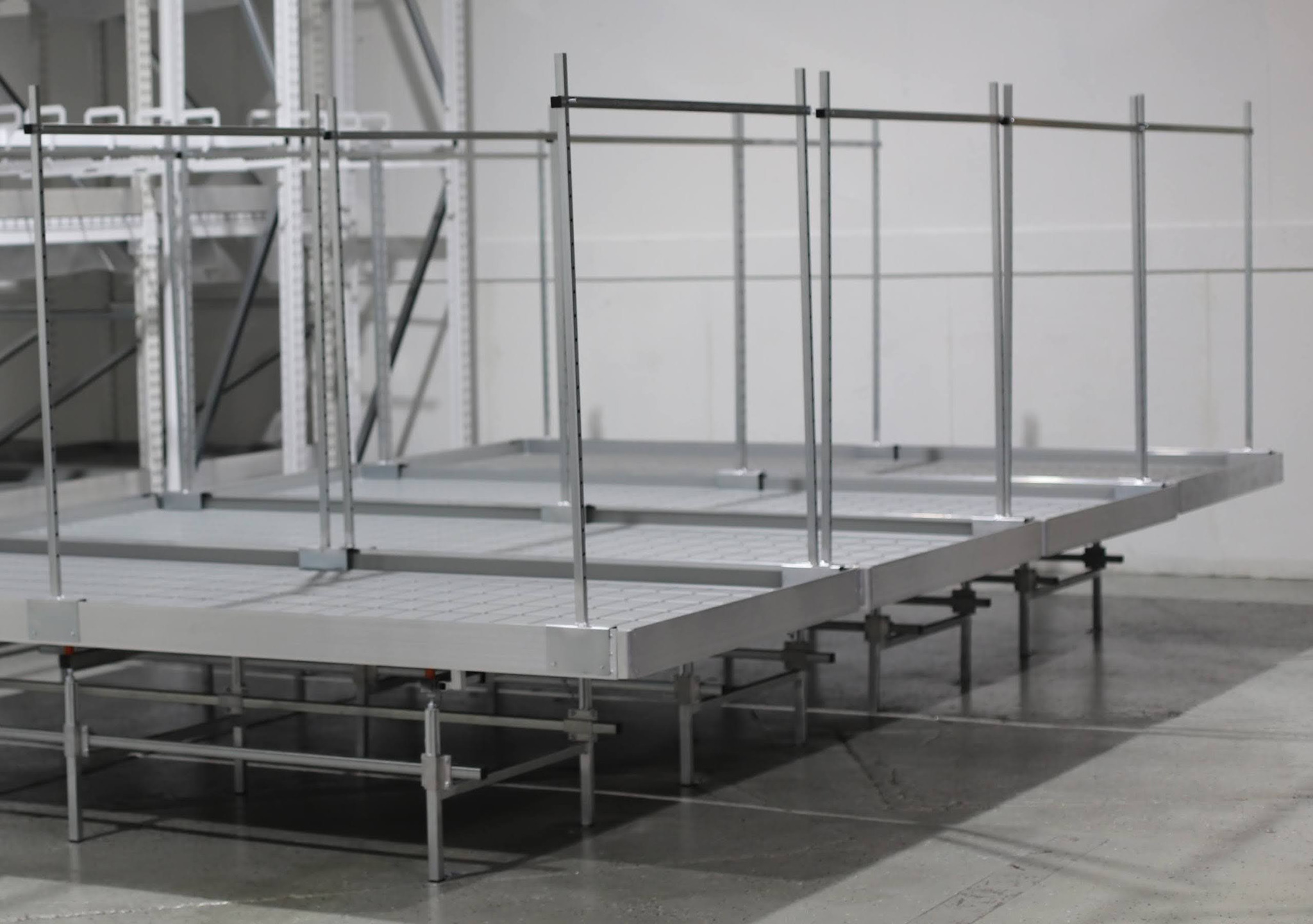Raised industrial platform side view showing deck panels upright posts and support legs