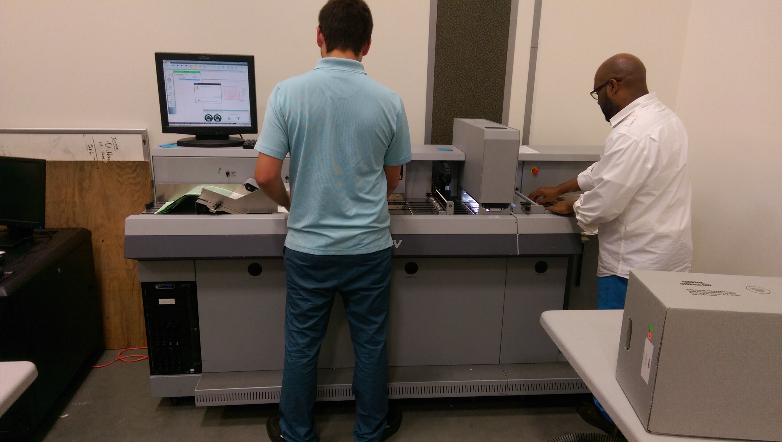 Workers scanning documents for digital storage and file conversionss