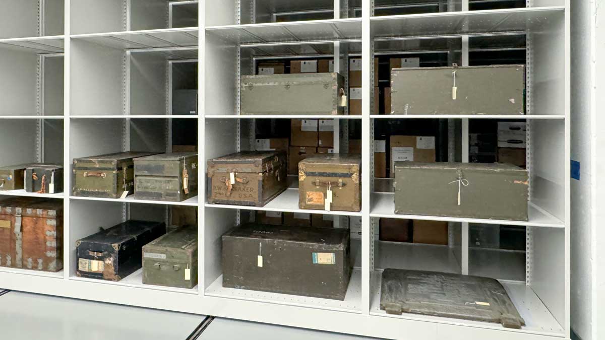 white four post metal shelving storing archival boxes