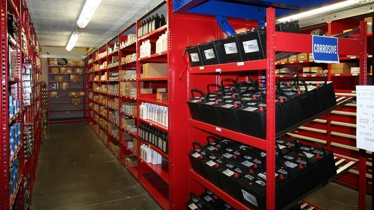 heavy-duty automotive shelving storing batteries and maintenance supplies for organized parts access