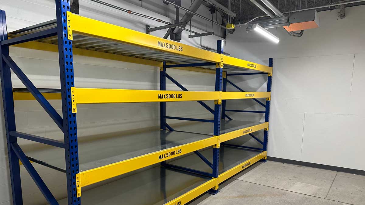 blue and yellow industrial shelving with steel beams marked max 5000 lbs per shelf