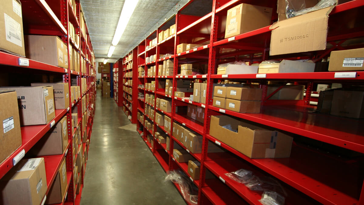 metal shelving holding boxed automotive parts for streamlined warehouse organization and fast retrieval
