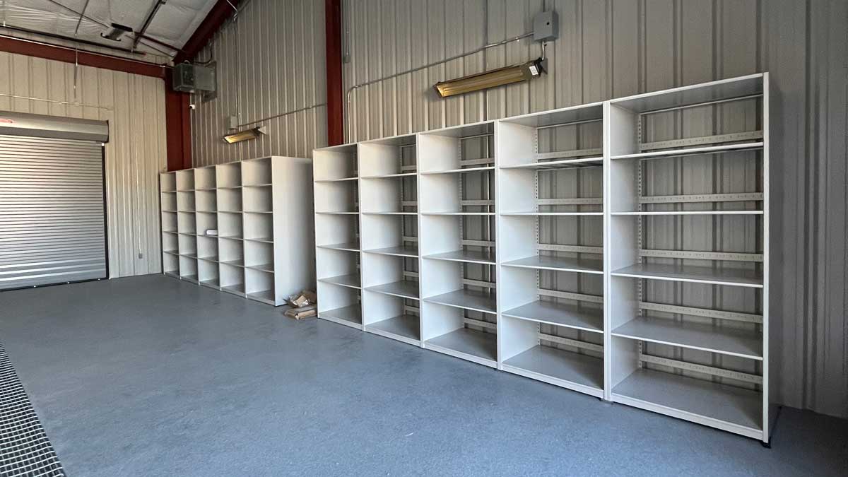 white steel modular shelving units in metal interior storage room