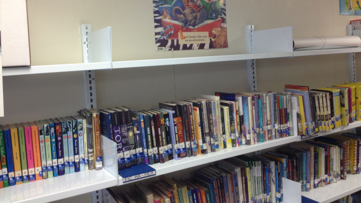 Commercial adjustable wall shelving providing flexible configurations for display and storage
